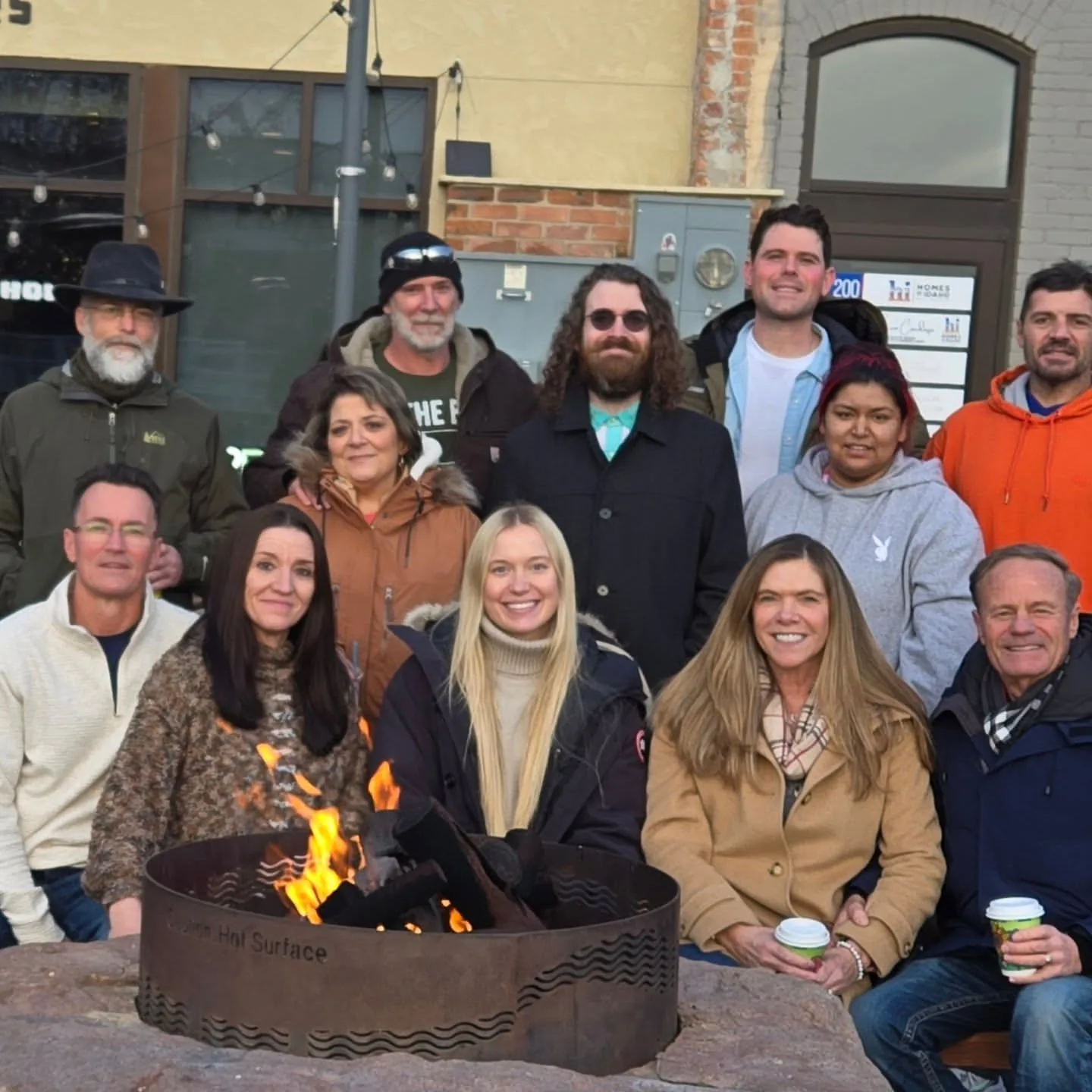 The Rising Sun Sober Living team and residents gathered together around an outdoor fire pit